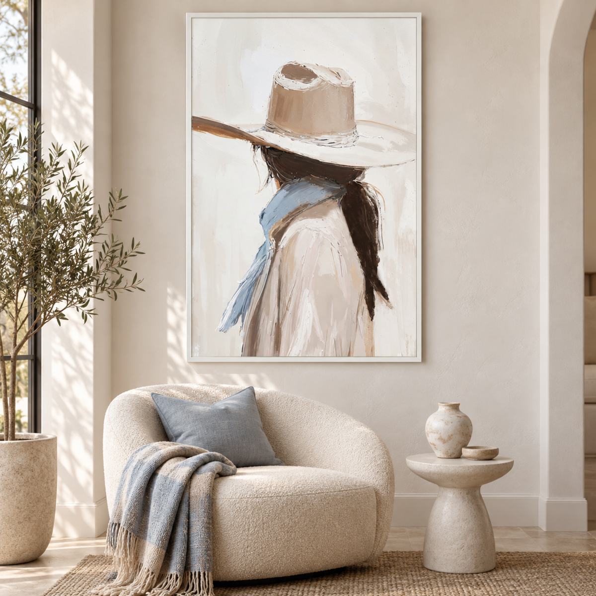 Cowgirl by Lady Hana in a white floating frame above a cream boucle chair with soft blue accents.