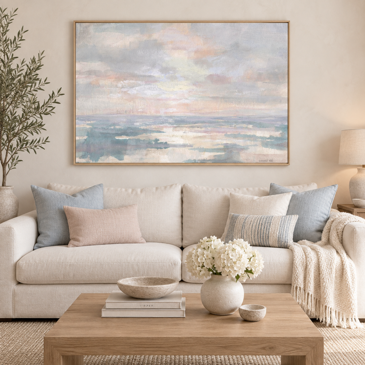 Still Water wall art centred above a light coastal sofa